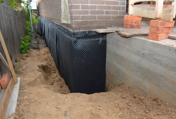 SJ Waterproofing Pros technician performing targeted Wet Basement Repair assessment in Alma, MI